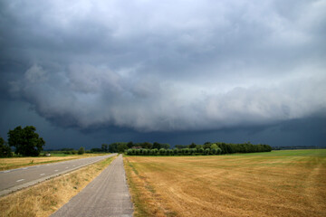 Big wall cloud above the fields in Overijssel in the Netherlands with thunderstorms coming up