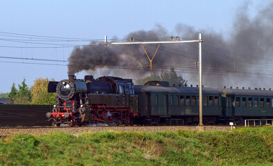 Fototapeta na wymiar Steam touristic train of SSN from museum rides through Nieuwerkerk aan den IJssel
