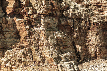 Grungy cragged bumpy pitted cavity stone facade, split layer gap.Ruined cracked shattered worn rough hiking canyon.Old ragged grunge steep marble cliff. Grand vintage crannied damaged impressive gorge