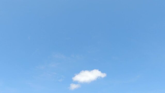 Clear blue sky n fluffy white cloud or cumulus cloudscape in tropical summer sunlight n bright sun light ray at daylight sunshine day, stop motion 4k TimeLapse