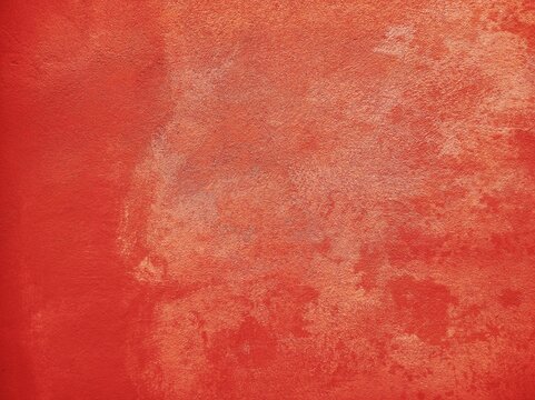 Grunge splashed red orange design, abstract messy warm autumn background, grain illustration backdrop.Orange wall with rustic texture made with mortar..Red wall of a renovated italian farmhouse.