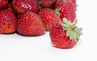 Strawberries on a white background. Strawberry close-up isolated. Juicy berries picked for dessert.