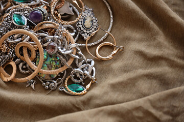 Bunch of stolen jewelry on military uniform cloth fabric. Looting by Russian soldiers in the...