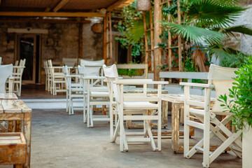 Empty cafe terrace with white furniture on the street