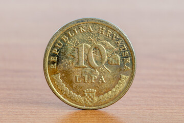Croatian coin 10 lipa on wooden table.
