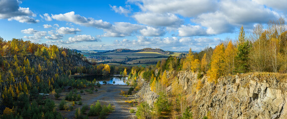 flooded quarry with trees around in autumn