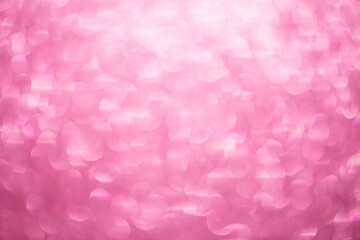 Pink bokeh background. Festive, Christmas shiny background. Sparkling pink light.