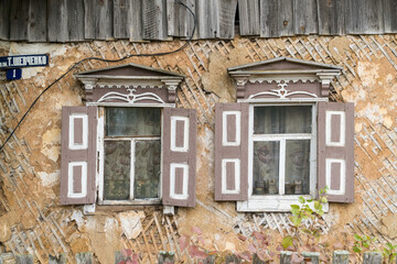 Carved wooden windows in old wooden houses in Oleshnia village, Chernihiv region, Ukraine.