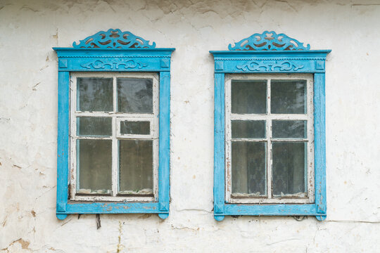 Carved wooden windows in old wooden houses in Oleshnia village, Chernihiv region, Ukraine.