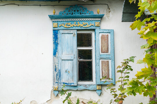 Carved wooden windows in old wooden houses in Oleshnia village, Chernihiv region, Ukraine.