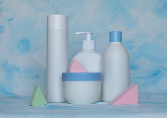 Bottles for cosmetic products without a label. Facial skin care concept. Background texture. Sponges for makeup