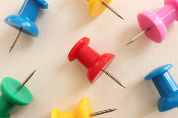 Close up image of push pins over pastel background