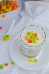 Colored candied fruits on oatmeal mousse with chia, flax and yogurt