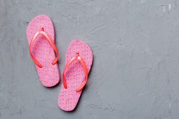 Flat lay composition with flip flops and seashell on colored background. Space for text top view