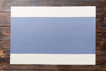 Top view of blue tablecloth for food on wooden background. Empty space for your design