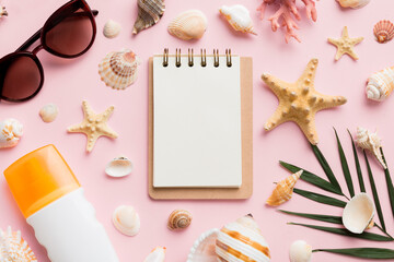 Blank writing book with summer beach accessories on background, copy space. Flat lay with copy space