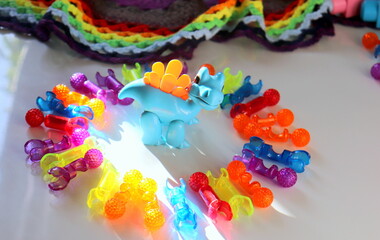 Children's multi-colored toys in the form of unusual figures close-up selective focus on a light surface, logic games for children.