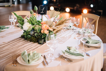 Amazing wedding table decoration with flowers on a round festive table