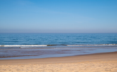 A beautiful calm day at the beach with blue skies