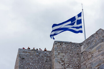ATHENS, GREECE, 12 DECEMBER 2021 Greek flag waving on the top of Acropolis