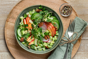 Healthy apple, celery cucumber, radish and microgreens salad