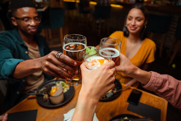 Diverse friends out for dinner celebrating cheers 