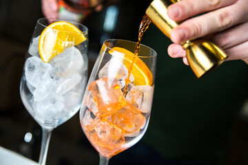 The bartender makes a cocktail. Pouring alcohol from a bottle. Ice cocktail