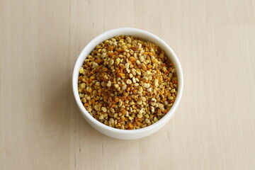Bee pollen propolis. brown, blue, orange and yellow flower pollen grains or bee food. İsolated on wooden background