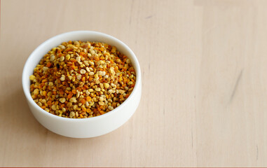 Bee pollen propolis. brown, blue, orange and yellow flower pollen grains or bee food. İsolated on wooden background