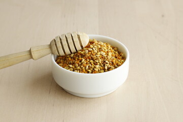 Bee pollen propolis. brown, blue, orange and yellow flower pollen grains or bee food. İsolated on wooden background