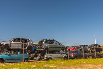 Den Helder, Netherlands, May 2022. Stacked old vehicles at a junkyard.
