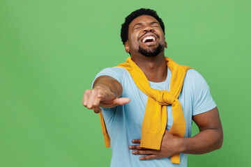 Young fun man of African American ethnicity 20s wearing blue t-shirt point index finger camera on...