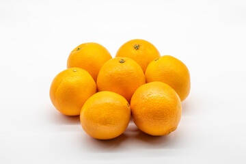 Group of ripe oranges isolated on a white background.