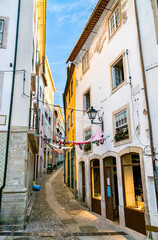 Fototapeta na wymiar Narrow street in the old town of Coimbra in Portugal