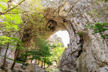 Imposing natural stone arches, Geomorphological natural monument. Vratna River Canyon, eastern Serbia. Amazing nature landscape. Spring day. 