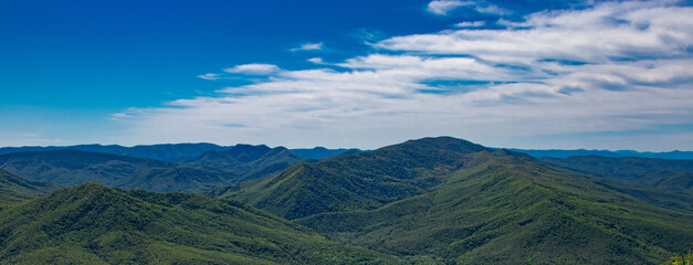 Plakat panorama of a beautiful mountainous area. sunny in the afternoon. beautiful spring landscape in the mountains.