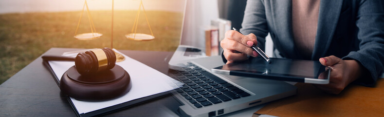 justice and law concept.Male judge in a courtroom on wooden table and Counselor or Male lawyer working in office. Legal law, advice and justice concept.