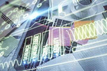 Education hologram drawings over computer on the desktop background. Top view. Multi exposure.