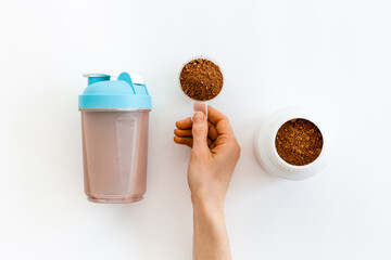 Hands making shake with whey protein. Fitness and gym diet nutrition