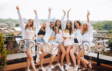 Bachelorette party. Happy and cheerful group of women friends together dancing and having fun on...