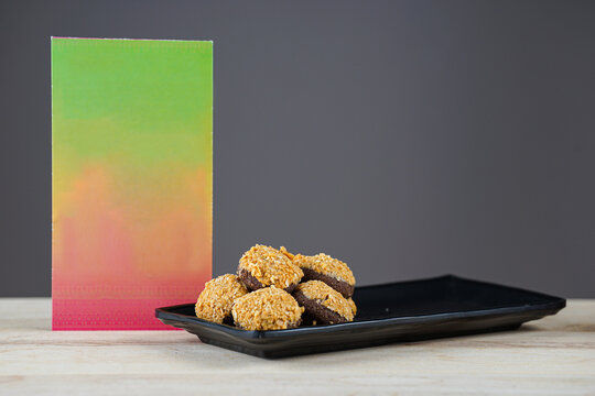 Hari Raya Envelope With Biscuits At Wooden Table 