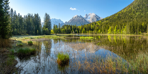 Panorama view of idyllic Taubensee near Ramsau, snow covered Hochkalter in spring, Berchtesgaden, Bavaria, Germany