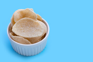 Prawn crackers on blue background. Shrimp crispy rice snack