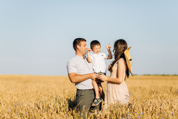 Baby Shower party in a wheat field. Man, woman and child at a gender party. Celebration. Pregnancy. Family. The concept of fatherhood.