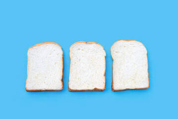 Sliced of bread on blue background.
