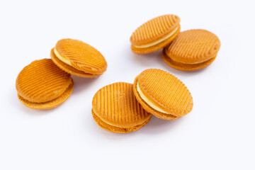 Custard cream sandwich biscuits on white background.