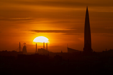 Skyscraper and St. Isaac's Cathedral against the backdrop of the setting sun.