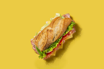 Submarine sandwich with ham, cheese, lettuce, tomatoes,onion, mortadella and sausage on yellow...