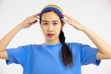 Studio portrait of asian woman with rainbow headband looking at camera. LGBT pride month concept