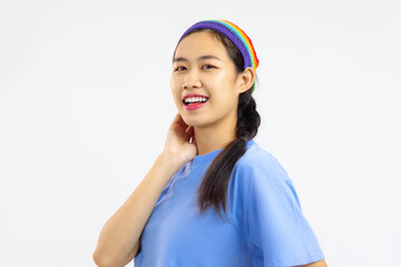 Studio portrait of happy asian woman with rainbow headband isolated white background. LGBT pride month concept
